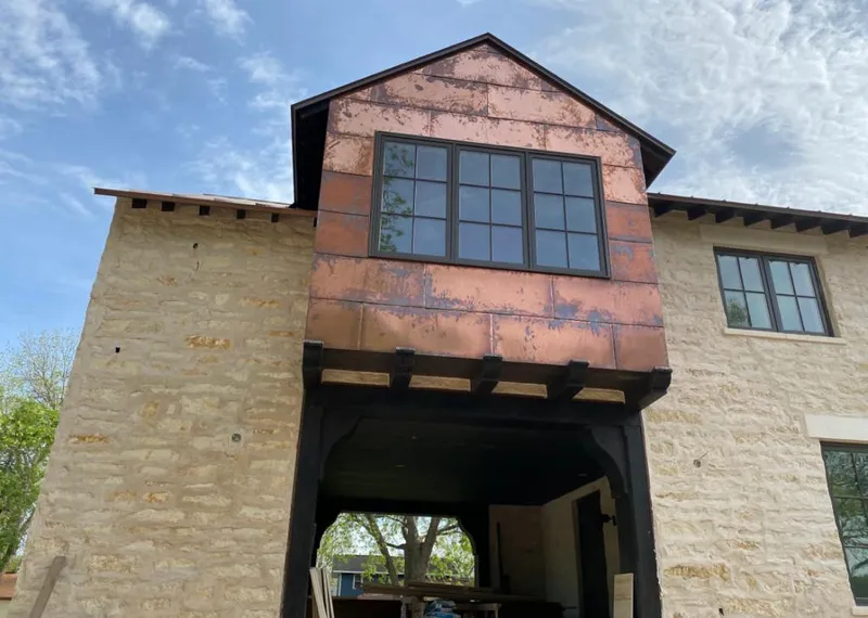 Copper metal panel facade on a stone building for Skylight Installation in Roanoke Rapids