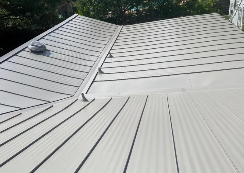 Solar attic fan installed on a metal roof for Roof Ventilation in Roanoke Rapids